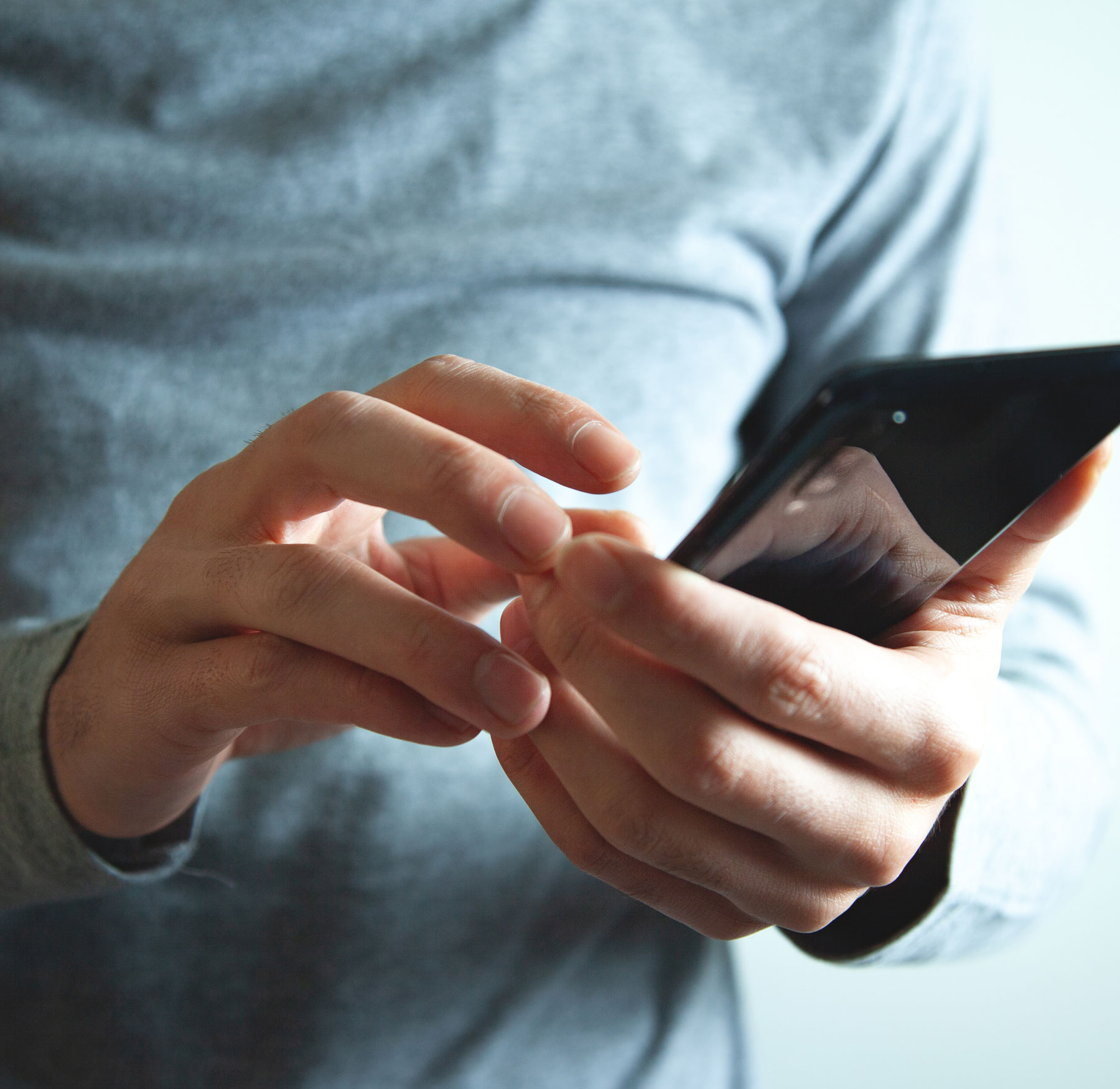 Close up of man using cell phone