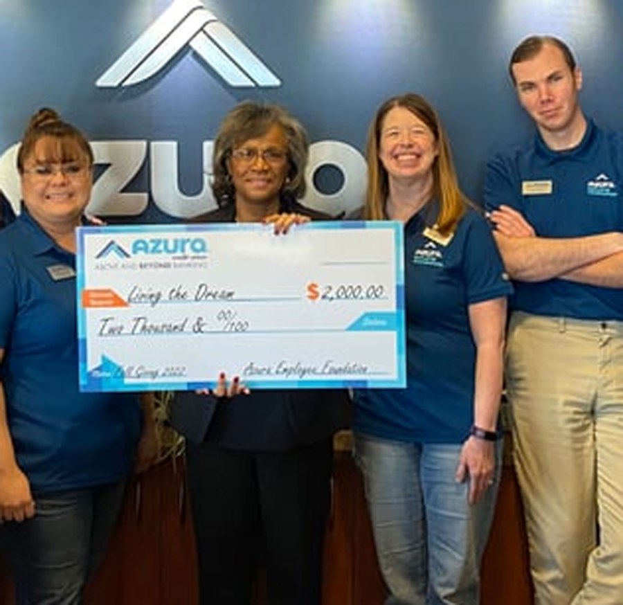 Azura employees giving a check to the 2022 grant recipients