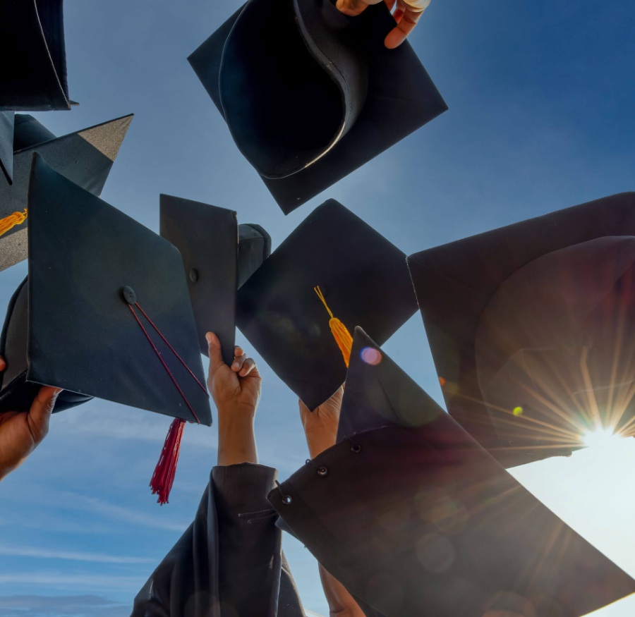 graduation caps thrown in the air