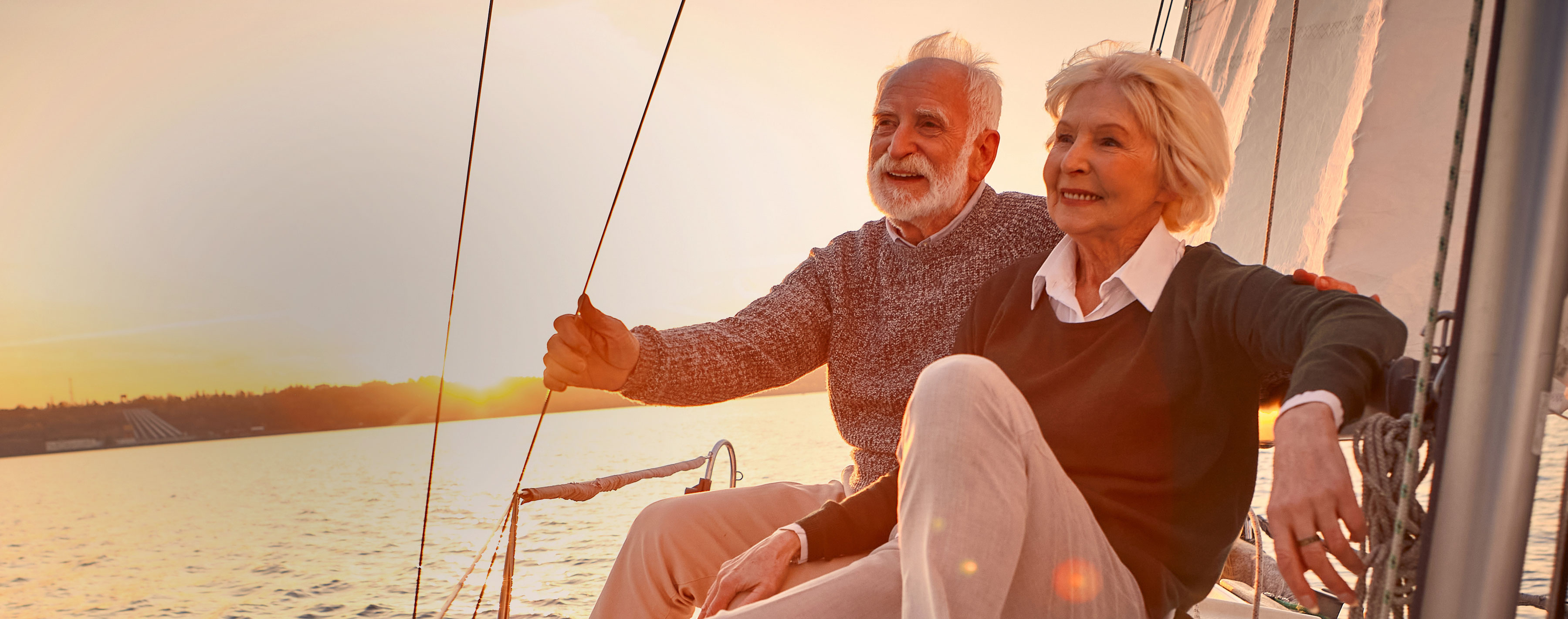 Happy retired couple on sail boat