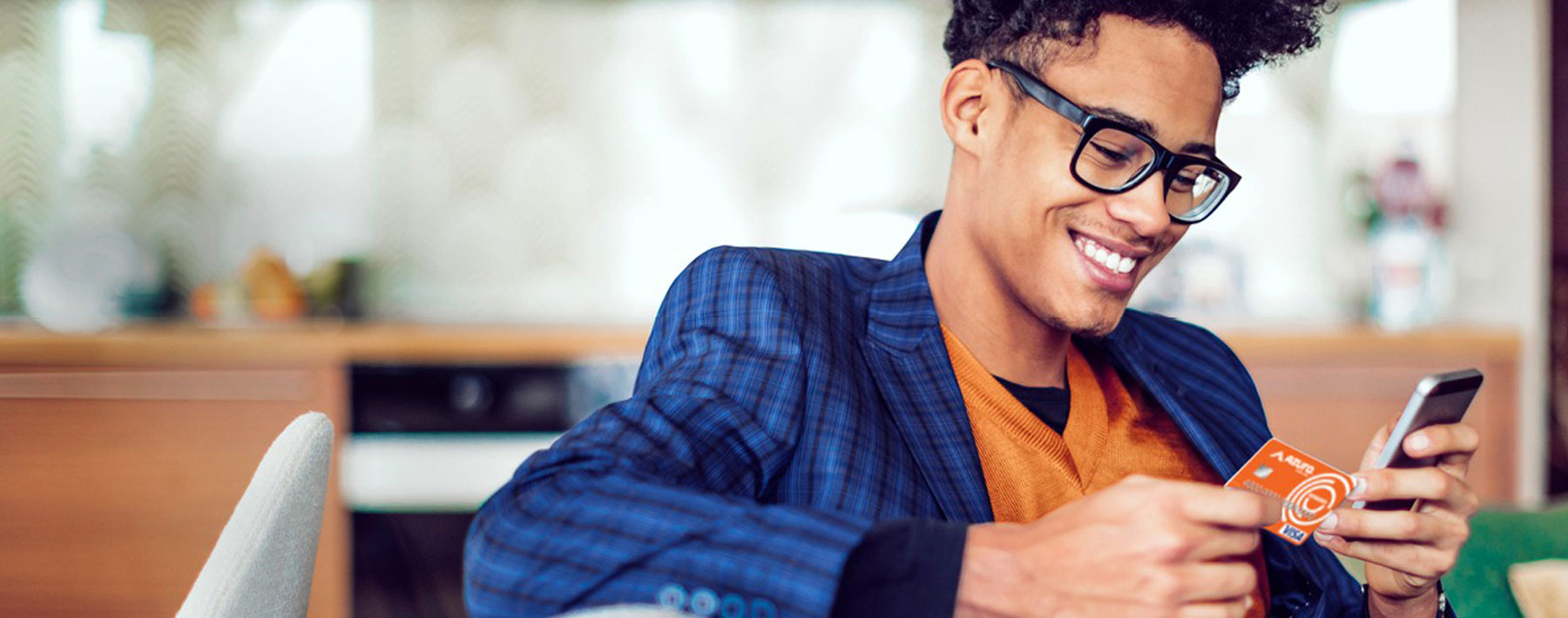 Young man using credit card and mobile phone