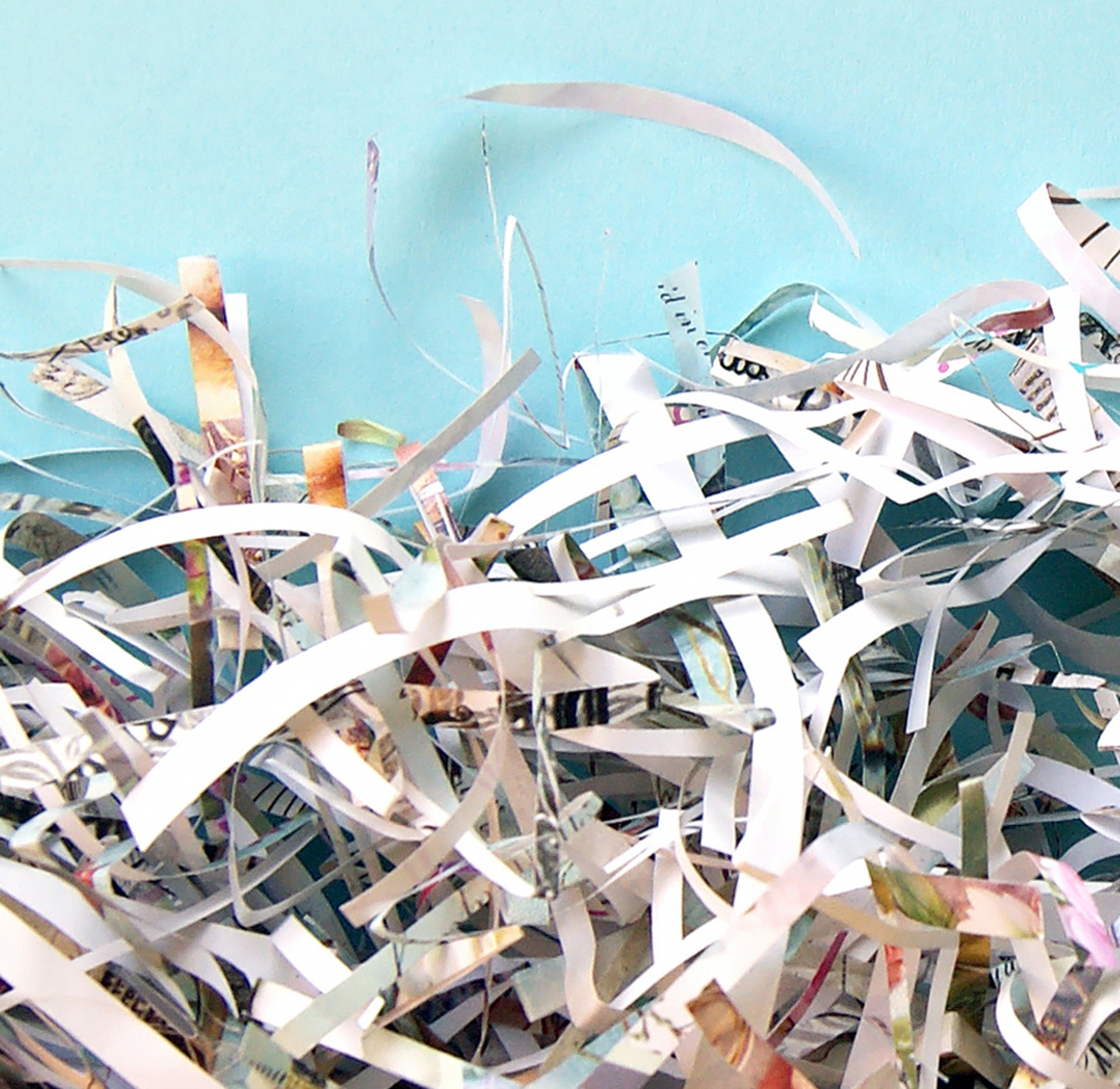 shredded paper on a light blue background