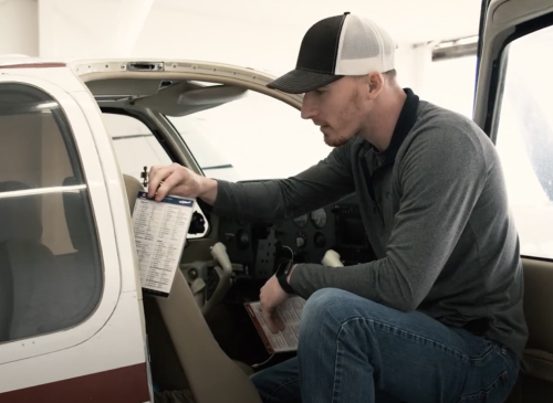 man inspecting a vehicle