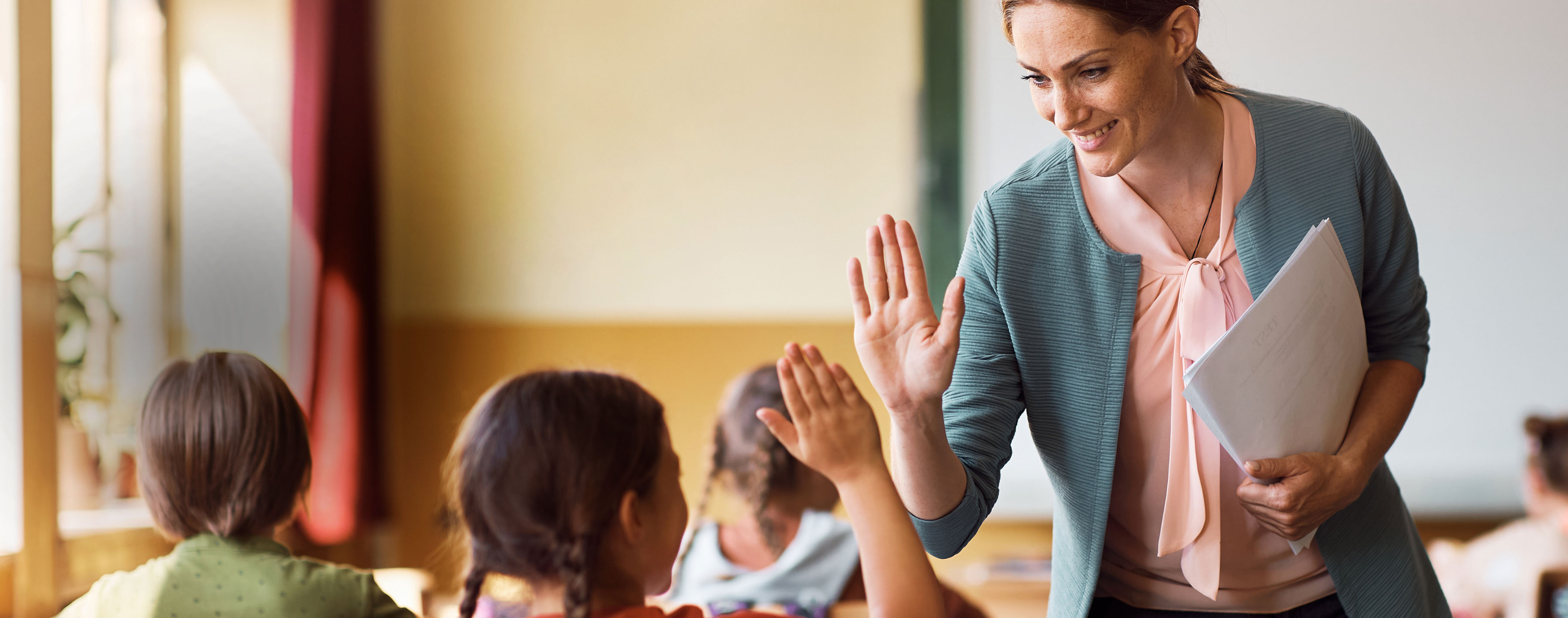 teacher giving a high-five to student