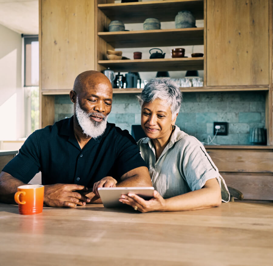 an older couple looking at their tablet