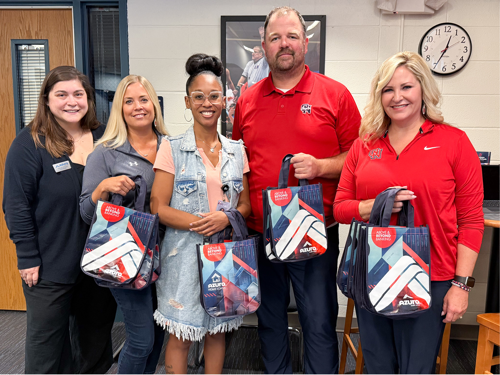 Azura staff and school teachers pose with gift bags