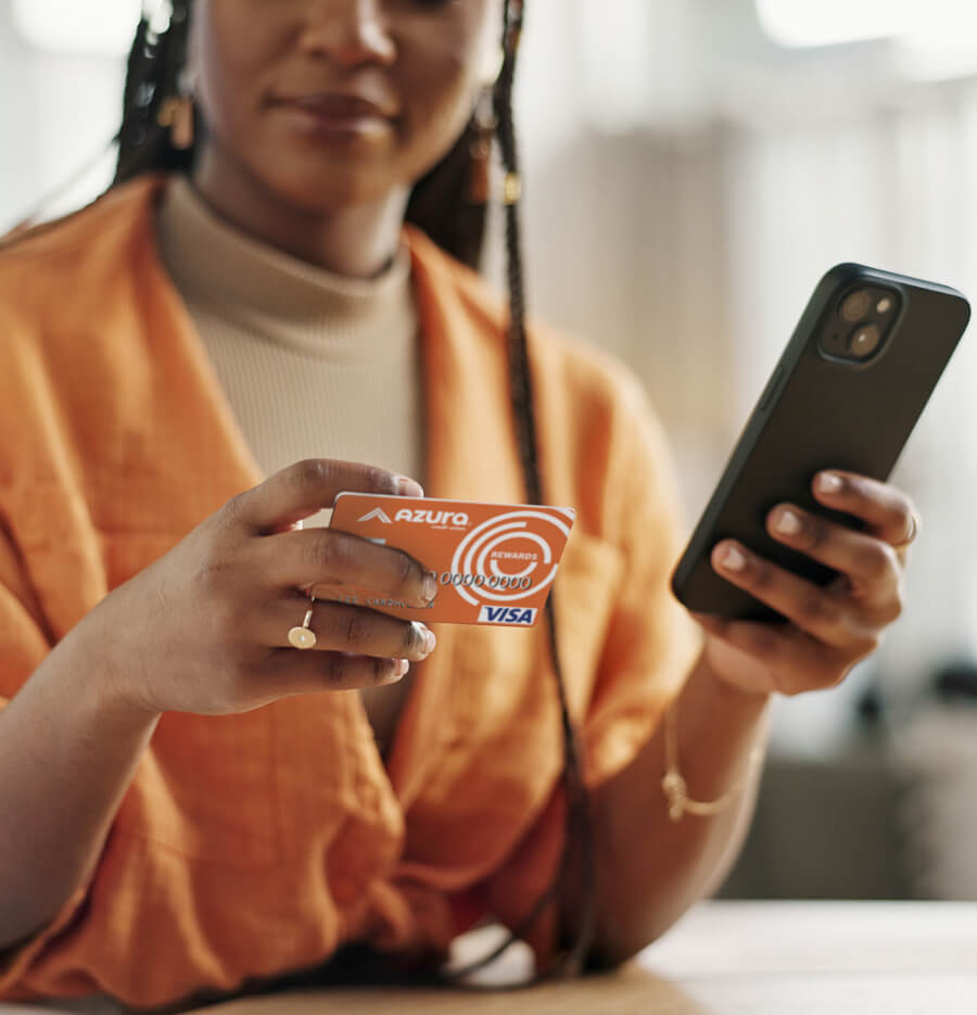 a woman using an AZURA credit/debit card for a mobile purchase